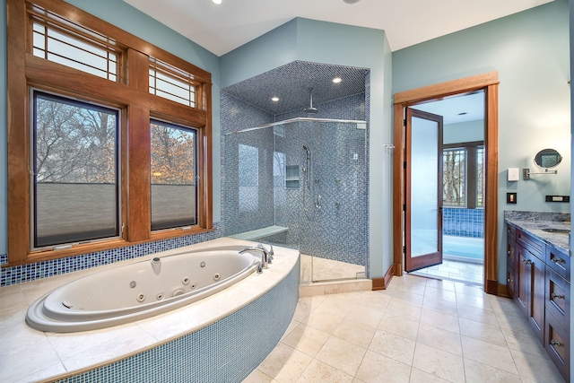 bathroom featuring a stall shower, a tub with jets, vanity, and tile patterned floors