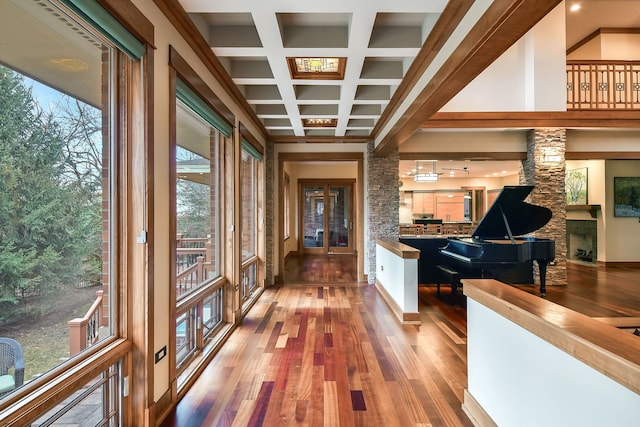 hallway with hardwood / wood-style floors, beam ceiling, coffered ceiling, and french doors
