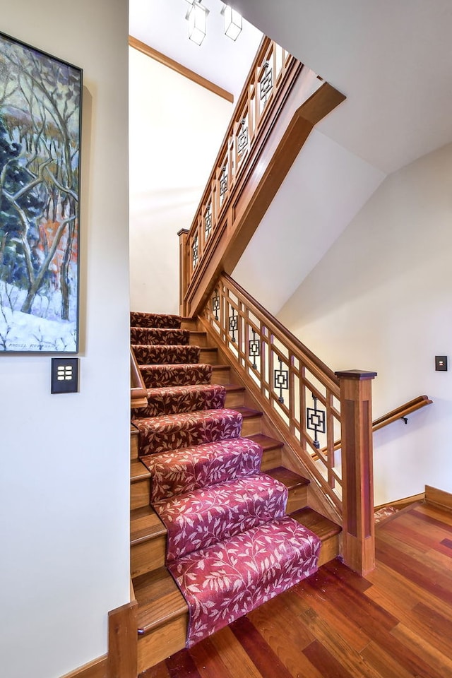 stairs featuring wood finished floors