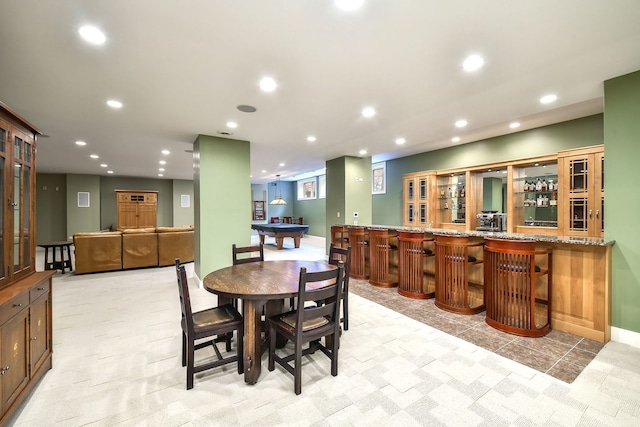 dining area featuring bar, recessed lighting, and light tile patterned flooring