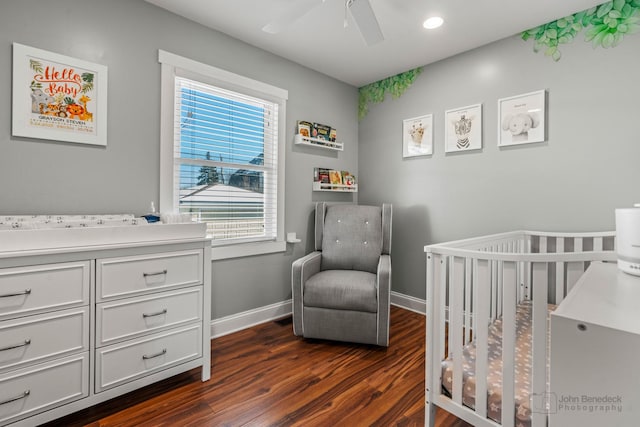bedroom featuring baseboards, recessed lighting, dark wood-style floors, a ceiling fan, and a nursery area