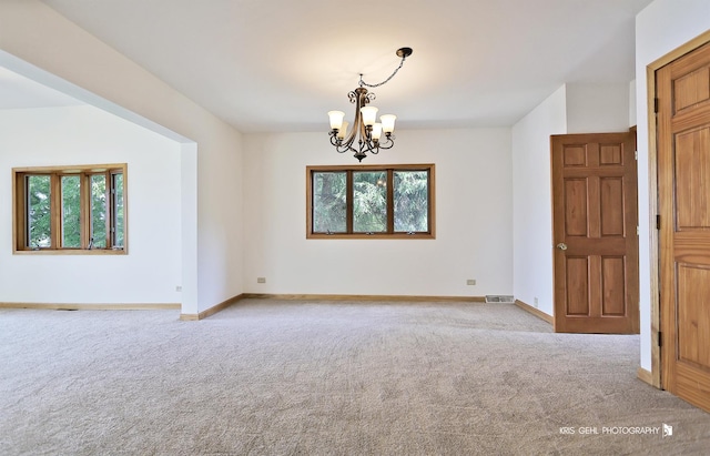 536 Circle Dr, Fox Lake, IL 60020 - unfurnished room featuring a chandelier, carpet flooring, and plenty of natural light
