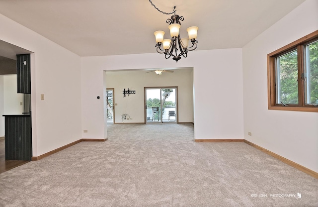 536 Circle Dr, Fox Lake, IL 60020 - carpeted empty room with a chandelier and ceiling fan