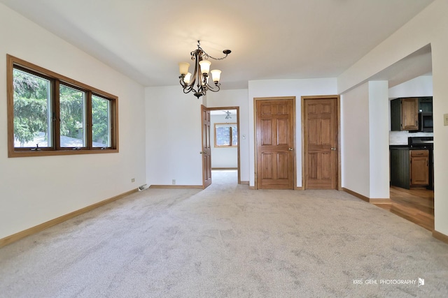 536 Circle Dr, Fox Lake, IL 60020 - unfurnished dining area featuring a chandelier and light colored carpet