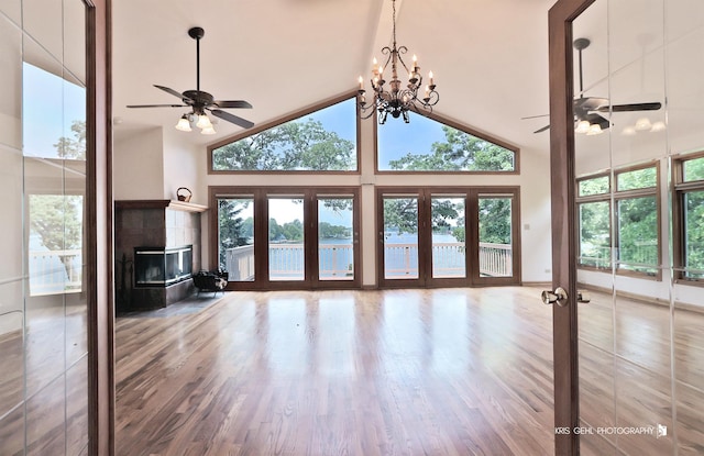 536 Circle Dr, Fox Lake, IL 60020 - unfurnished living room with a ceiling fan, french doors, high vaulted ceiling, wood finished floors, and a tiled fireplace