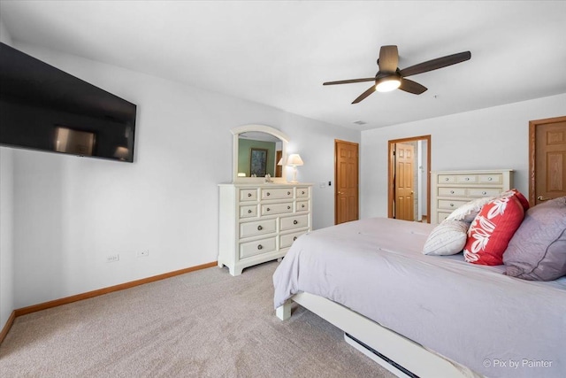 carpeted bedroom featuring baseboards and ceiling fan
