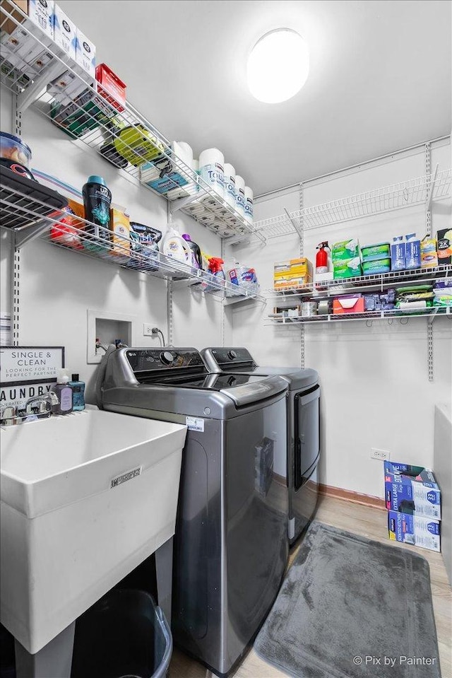 laundry room with a sink, laundry area, and washing machine and clothes dryer
