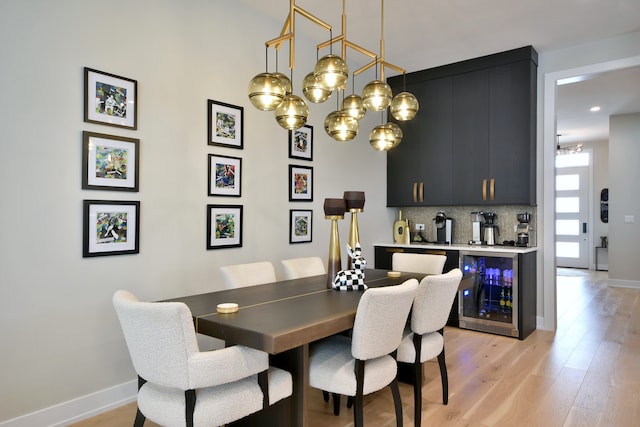 262 N Addison Ave, Elmhurst, IL 60126 - dining space with beverage cooler, light wood finished floors, a chandelier, and bar