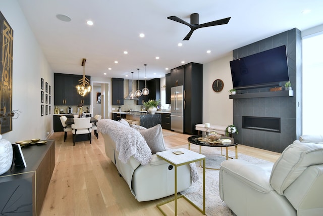 262 N Addison Ave, Elmhurst, IL 60126 - living area featuring a chandelier, light wood-style floors, ceiling fan, recessed lighting, and a tiled fireplace
