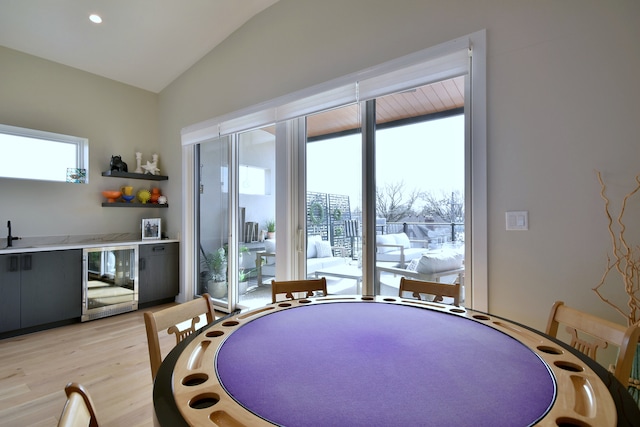 262 N Addison Ave, Elmhurst, IL 60126 - dining room featuring wine cooler, vaulted ceiling, and light wood finished floors