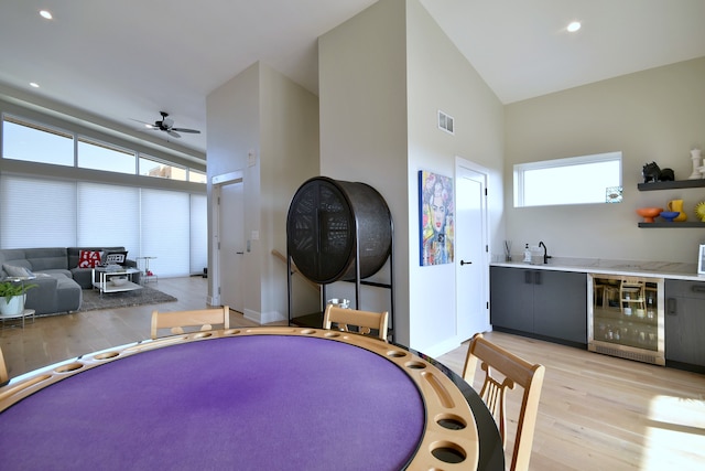262 N Addison Ave, Elmhurst, IL 60126 - recreation room featuring wine cooler, light wood finished floors, a ceiling fan, high vaulted ceiling, and recessed lighting
