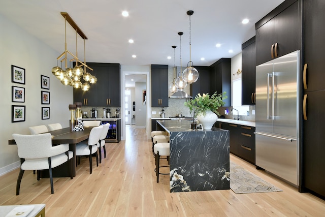 262 N Addison Ave, Elmhurst, IL 60126 - kitchen with appliances with stainless steel finishes, wall chimney exhaust hood, dark cabinetry, and recessed lighting