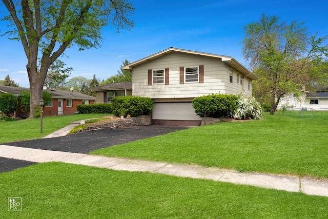632 Columbine Ave, Lisle, IL 60532 - tri-level home with a garage, asphalt driveway, and a front lawn
