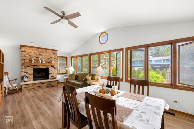 632 Columbine Ave, Lisle, IL 60532 - dining area with a ceiling fan, lofted ceiling, light wood-style floors, a fireplace, and baseboards