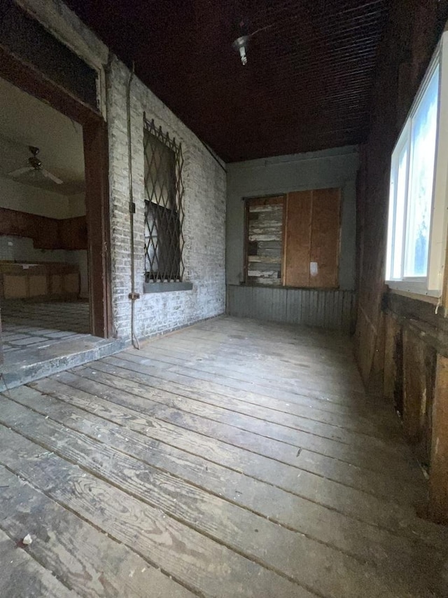 unfurnished room with ceiling fan and hardwood / wood-style flooring