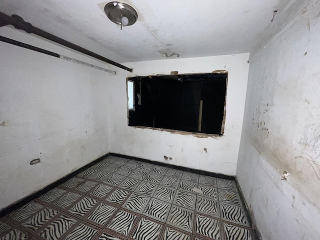 spare room featuring baseboards