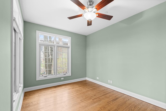 unfurnished room with light wood-type flooring, baseboards, and ceiling fan
