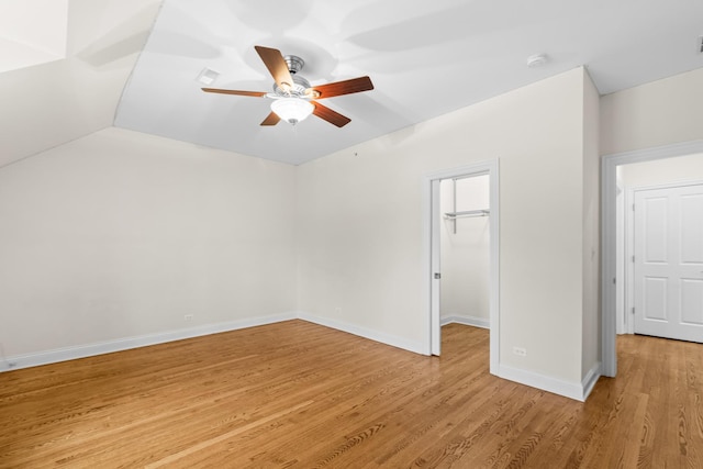 unfurnished room with ceiling fan, light wood-type flooring, and baseboards