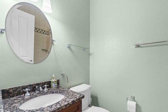bathroom featuring toilet and vanity