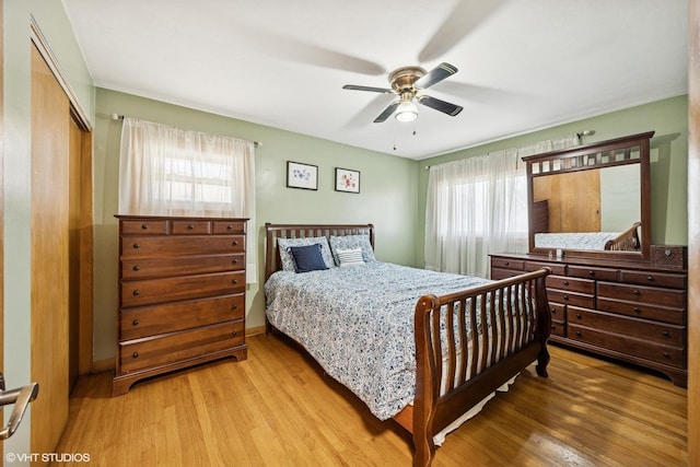 bedroom with light wood finished floors, a closet, and ceiling fan
