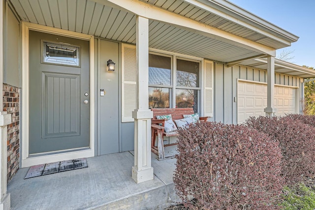 property entrance featuring board and batten siding and covered porch