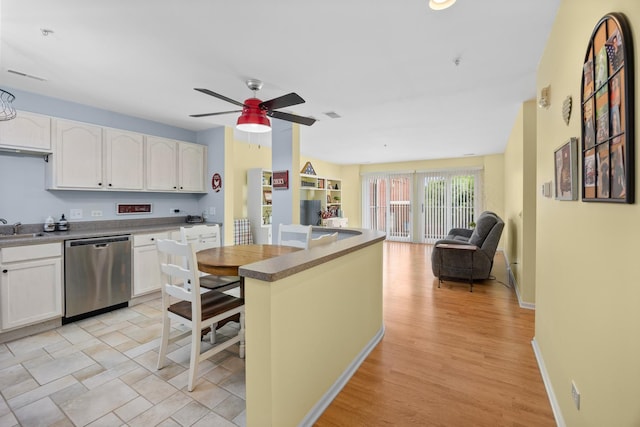17 E Hattendorf Ave Unit 205, Roselle, IL 60172 - kitchen featuring stainless steel dishwasher, open floor plan, a ceiling fan, white cabinets, and light wood finished floors