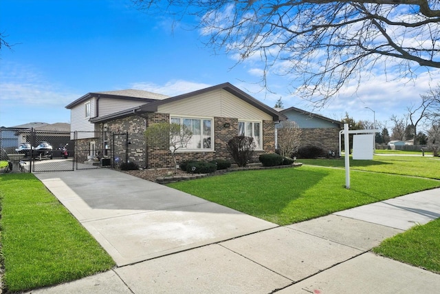 view of front of house with concrete driveway, brick siding, and a front lawn