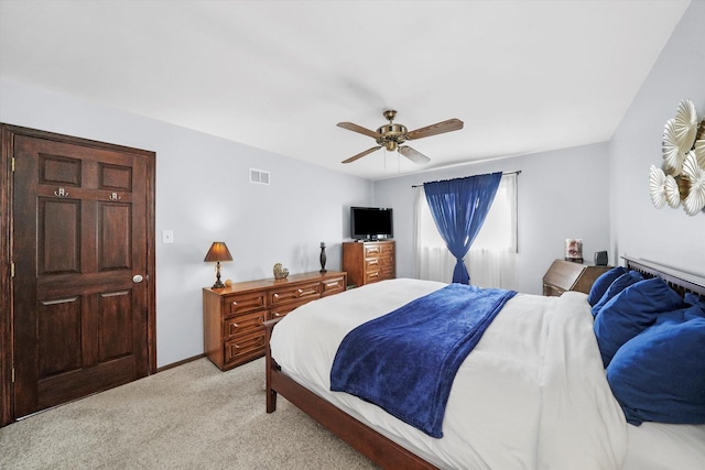 bedroom with baseboards, light colored carpet, ceiling fan, and visible vents