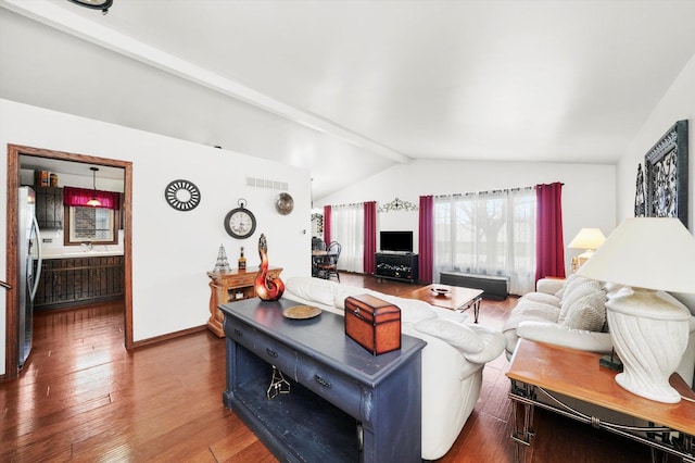 living area with wood finished floors, visible vents, lofted ceiling with beams, and baseboards