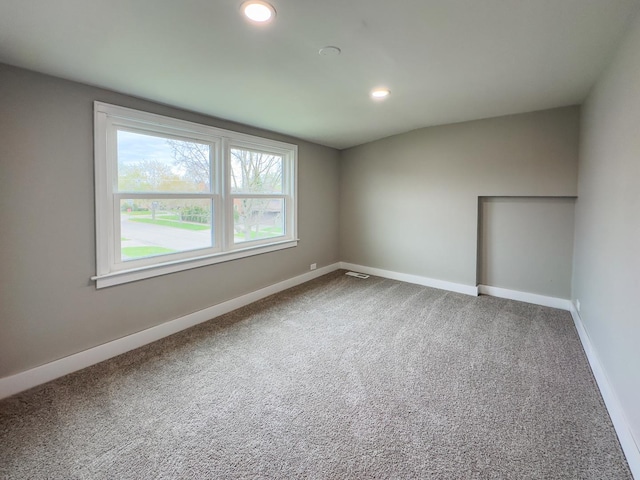 carpeted spare room with recessed lighting, visible vents, and baseboards