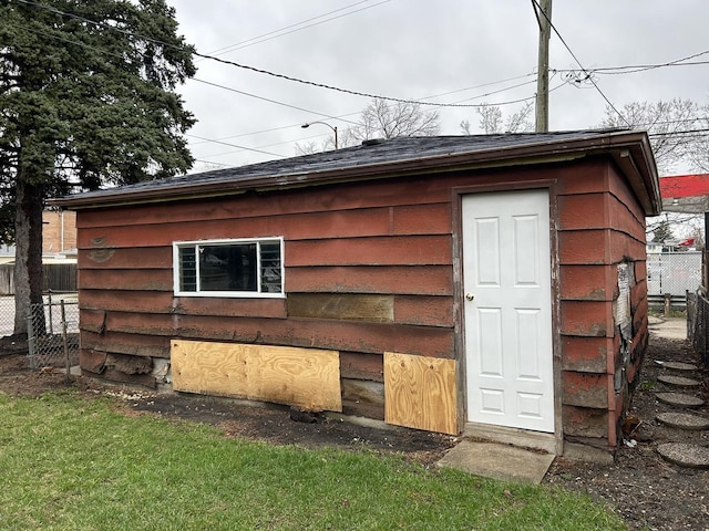 view of outbuilding featuring fence