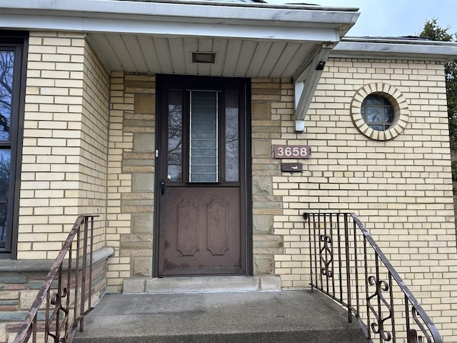 property entrance featuring brick siding