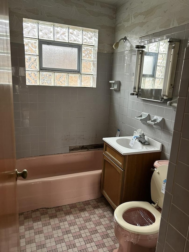 full bathroom with tile walls, bathtub / shower combination, vanity, decorative backsplash, and tile patterned flooring