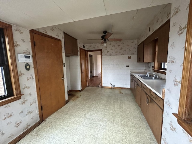 kitchen featuring ceiling fan, wallpapered walls, and light floors