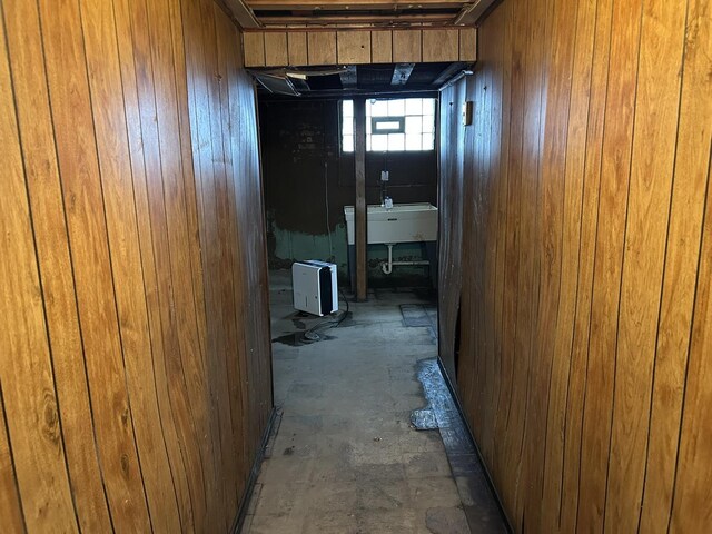 hall with a sink and wood walls