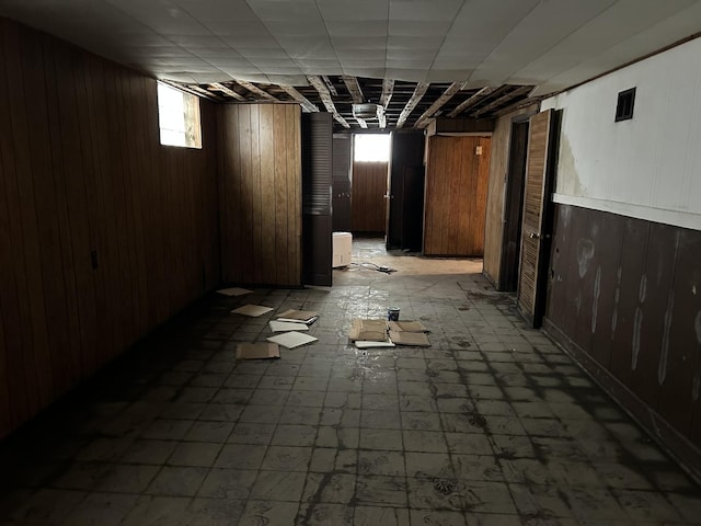 below grade area with wooden walls and light floors