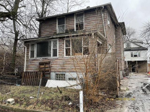 view of side of home featuring fence