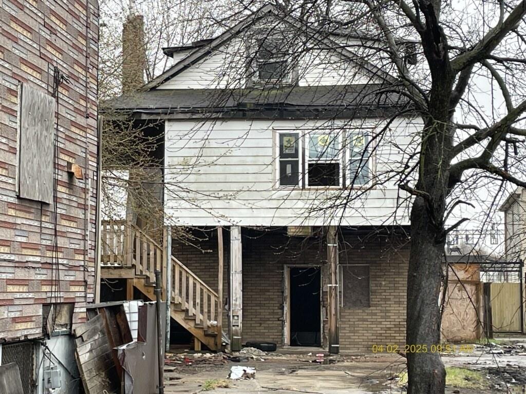 exterior space with stairs and brick siding