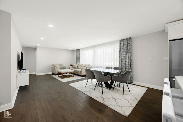 dining room with recessed lighting, dark wood-type flooring, and baseboards