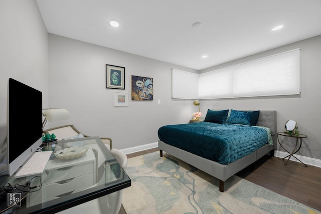 bedroom featuring wood finished floors, baseboards, and recessed lighting