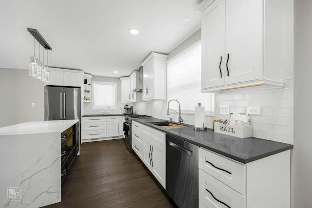 kitchen featuring dark wood finished floors, open shelves, a sink, stainless steel appliances, and decorative backsplash