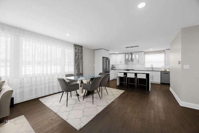 dining space with dark wood-style flooring, baseboards, and recessed lighting
