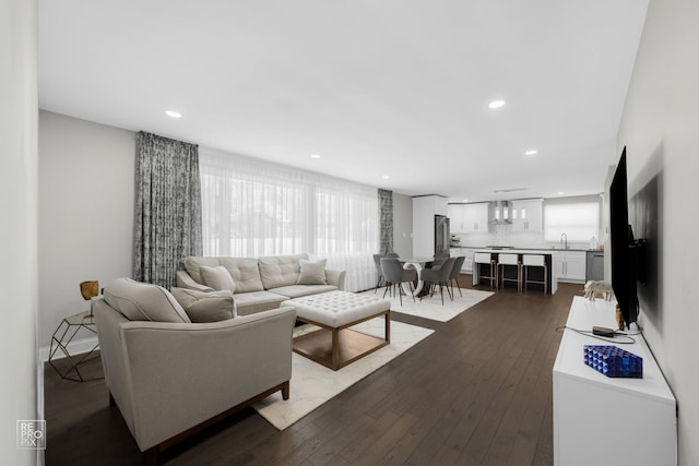 living area featuring recessed lighting and dark wood finished floors