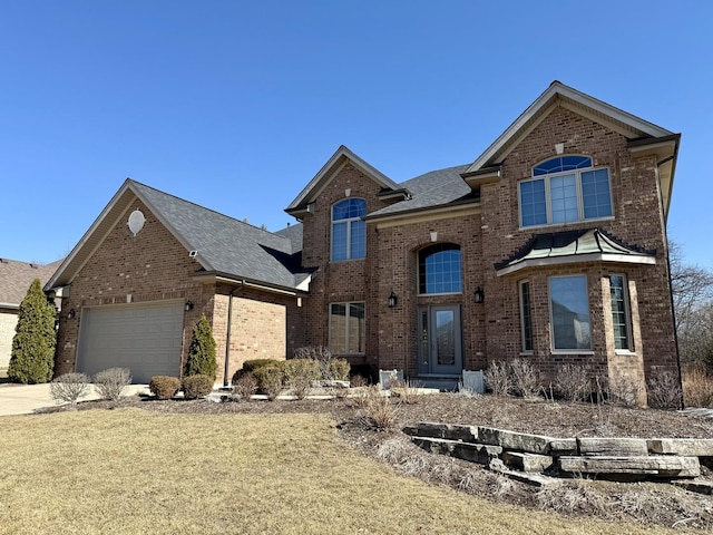 traditional-style home featuring a garage, roof with shingles, brick siding, and driveway