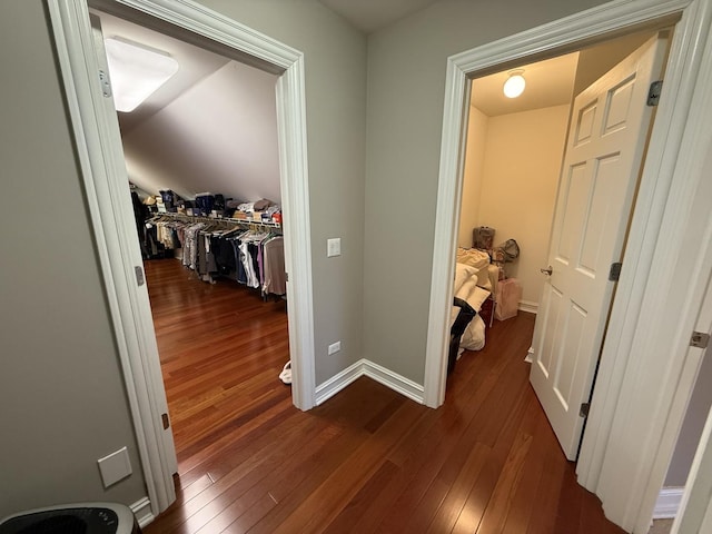 hallway with baseboards and dark wood-style floors