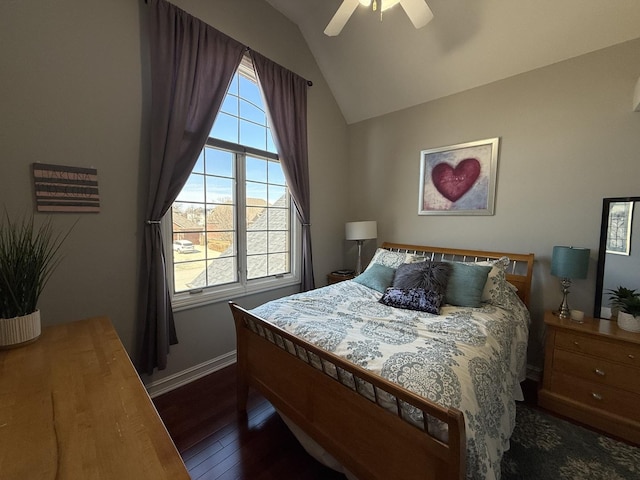 bedroom featuring baseboards, multiple windows, hardwood / wood-style flooring, and lofted ceiling
