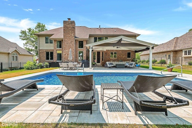 view of swimming pool with a fenced in pool, a patio, fence, and an outdoor hangout area