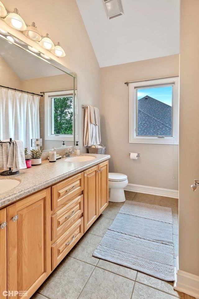 full bath with a sink, visible vents, double vanity, and lofted ceiling