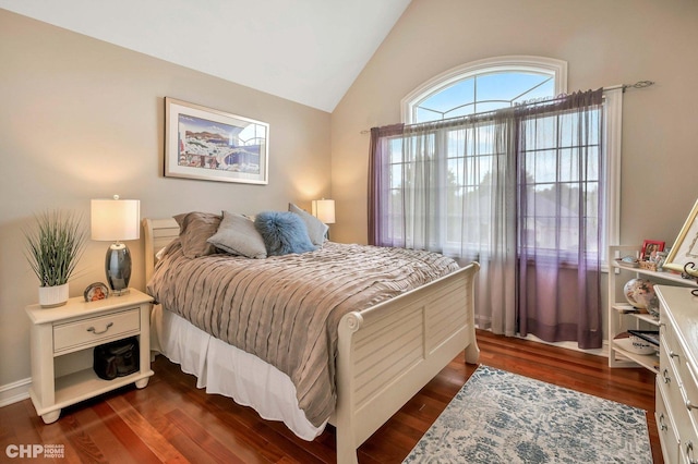 bedroom with dark wood-style floors and lofted ceiling