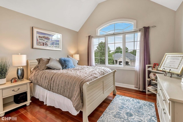 bedroom with dark wood-type flooring, baseboards, and lofted ceiling